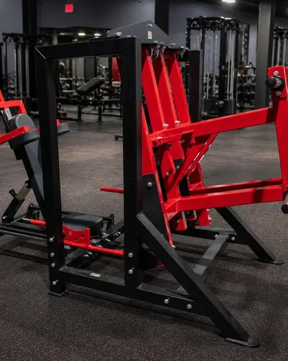 Citadel Strength 2n1 Hip Press in fire engine red and black on a gym floor.